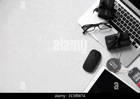 Gadgets with gifts on white grunge background. Cyber Monday Stock Photo