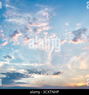 Beautiful sunset sky with delicate wispy clouds in soft pastel colors of pink, purple, and blue. High quality photo Stock Photo
