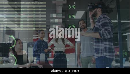Middle Eastern man in plaid shirt with VR headset gesturing in open-plan office, copy space Stock Photo