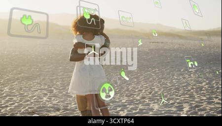 Couple embracing in dunes at golden hour wearing sleeveless white dress amid floating eco icons Stock Photo