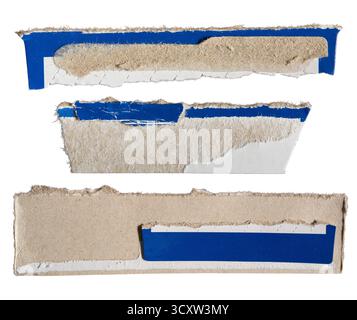 Pieces of torn paper box packaging featuring blue and white graphic design isolated on white background with clipping path Stock Photo