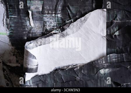 A piece of peeled white flag shape paper on glitchy black photo copy paper Stock Photo