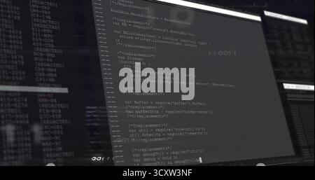 Displaying monitor showing JavaScript code and terminal logs at desk, with split view panels Stock Photo