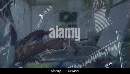 Typing female forearm and hand interacting with laptop at office workspace, with digital graphs Stock Photo