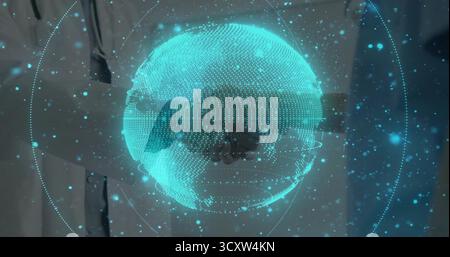 Hovering holographic globe rotating in office, showing lab coat and suit shaking hands Stock Photo