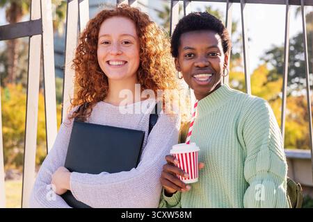 two young students smiling happy looking at camera Stock Photo