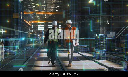 Two Engineers in Helmets and Safety Vests Walk Through High Tech Factory Enhanced by Glowing AR Grid. Concept of Smart Manufacturing, Industrial Innovation, Fusion of Humans With Digital Intelligence. Stock Photo