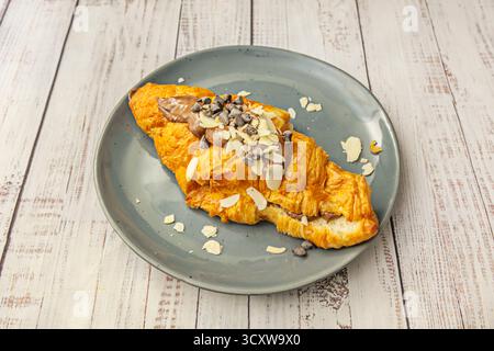 Classic croissant with braised beef, caramelized onions, and a red wine reduction on perfect puff pastry Stock Photo
