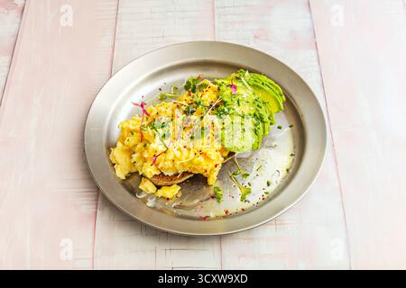 Classic croissant filled with a French omelet, fresh chives, and high-quality Norwegian smoked salmon Stock Photo