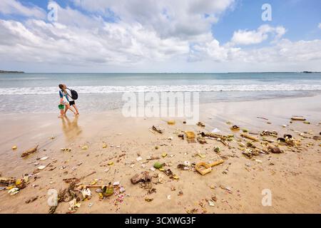 Remains of Balinese offerings washed up on the Jimbaran Beach by the sea. South Kuta, Badung, Bali, Indonesia. Stock Photo