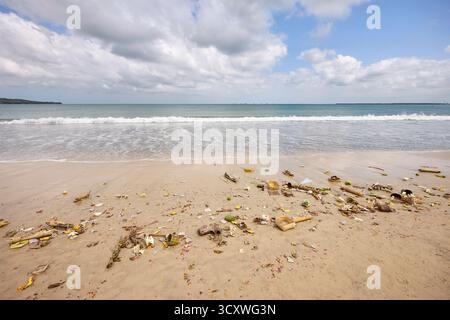 Remains of Balinese offerings washed up on the Jimbaran Beach by the sea. South Kuta, Badung, Bali, Indonesia. Stock Photo