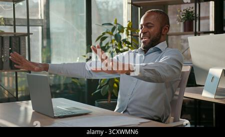 Successful businessman African American business man finish computer work end online project close laptop job done pause freedom break relaxing in Stock Photo