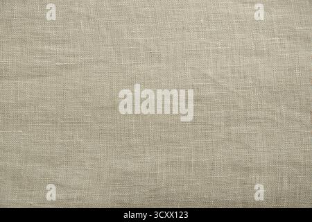 Close up view of oatmeal  linen woven fabric. Quality natural textile texture ideal for backgrounds or design Stock Photo