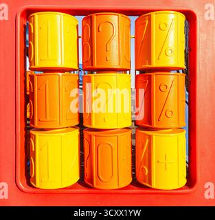 Children's game plastic panel of yellow and orange color, on which reels with various numbers and symbols Stock Photo