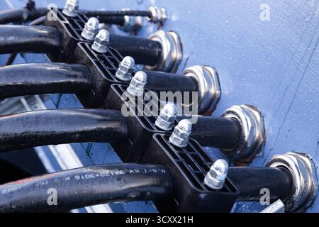 Several powerful electrical cables connected to a junction box Stock Photo