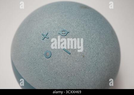 London, United Kingdom – 2025.10.16 – Close-up top view of a blue Amazon Echo Alexa smart speaker showing volume, microphone, and action buttons on a Stock Photo