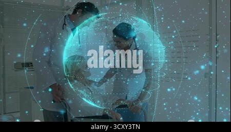 Hovering digital holographic globe projecting patient data in consultation room, glowing particles Stock Photo