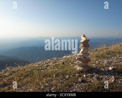 Stone Cairn on Mountain Ridge with Horizon Stock Photo