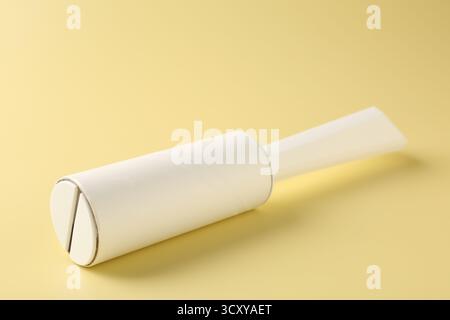 One lint roller on yellow background, closeup Stock Photo