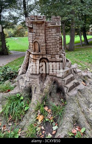 Myrtle Park, Bingley tree stump carving from an old beech tree. A castle on the hill. Stock Photo