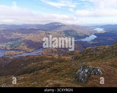 Panoramic view from Ben Venue summit over Loch Venacher, Loch Achray & Loch Katrine in Scotland’s Trossachs National Park – scenic Highlands landscape Stock Photo