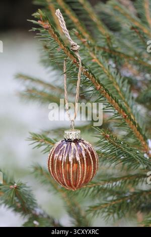 Close-up of a transparent glass brown Christmas ball on a Christmas tree Stock Photo