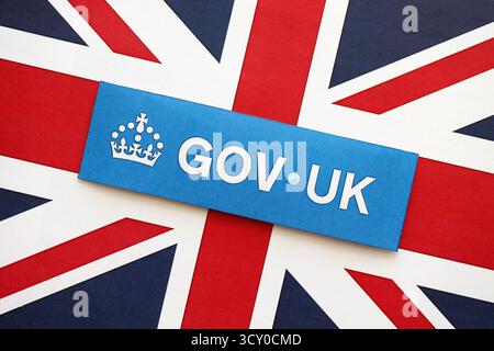 KYIV, UKRAINE - SEPTEMBER 17, 2025 Government GOV UK logotype sticker lies on UK flag close up Stock Photo