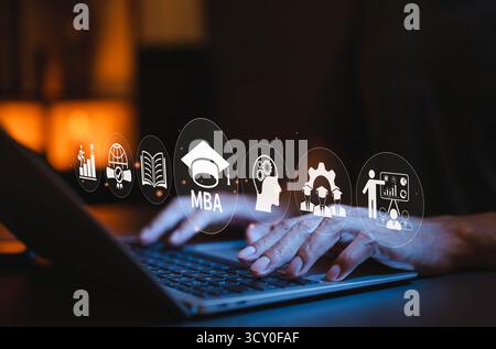 MBA Program Concept. Master of Business Administration. Businessman using laptop with MBA text and graduation cap icon, educational and professional Stock Photo