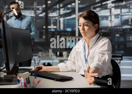 Data center programmer inspecting gear, doing maintenance tasks, checking performance. Server farm It specialist conducting system checks to ensure operational stability across network mainframes Stock Photo