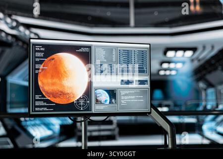 Close up of monitor in spaceship displaying detailed planetary scan of Mars. Screen in futuristic spacecraft showing red planet surface data telemetry details during space mission Stock Photo