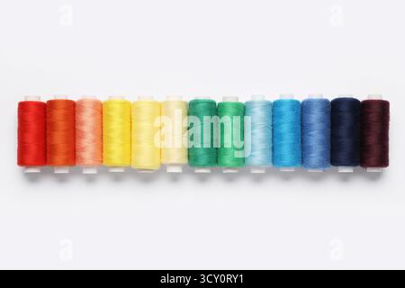 Set of different thread spools on white background Stock Photo