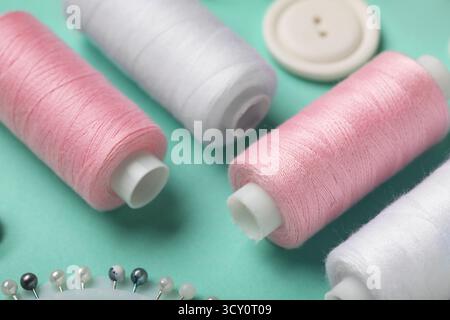 Composition with thread spools on mint background, closeup Stock Photo