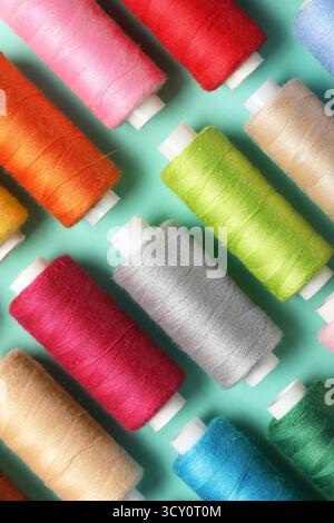 Set of different thread spools on mint background, closeup Stock Photo