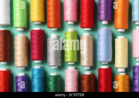 Set of different thread spools on mint background, closeup Stock Photo