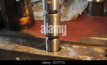 Mechanic placing bellows on hydraulic cylinder. Stock clip Stock Photo