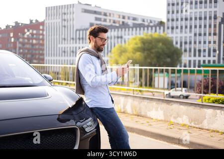 Man Using Phone Near Car Stock Photo