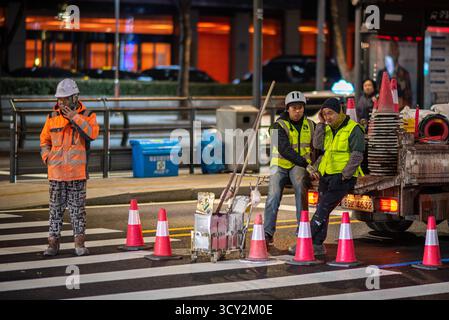 Nighttime roadwork scene with workers and traffic cones in Seoul, South Korea on 8 December 2023 Stock Photo