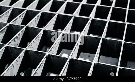 Close up metal grid texture with shadow, industrial steel pattern in black and white tone, abstract background for construction or engineering design Stock Photo