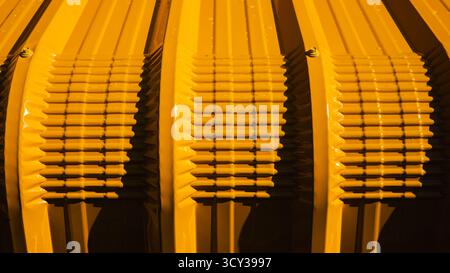 Close up yellow corrugated metal sheet texture with light and shadow, industrial abstract background, modern construction material pattern for archite Stock Photo