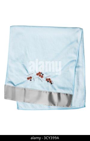 Light blue embroidered folded terry towel isolated over white Stock Photo