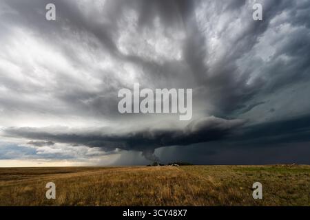 Menacing storm clouds fill the sky, bringing a threatening, dramatic scene with deep shadow, rich texture, and moody atmosphere Stock Photo