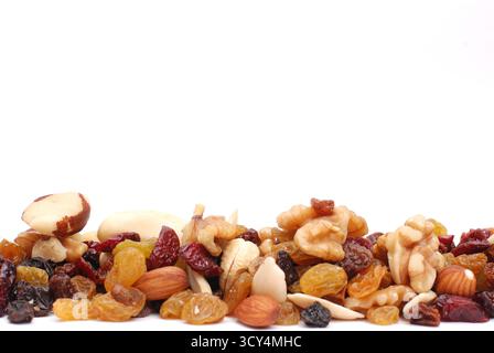 Mix Of Nuts And Dry Fruits Isolated On A White Background, Almonds, Walnuts, Hazelnuts And Raisins On A Pile, Healthy Food Stock Photo