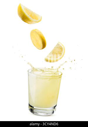 glass of lemonade with lemon slices falling, isolated on white background. Stock Photo