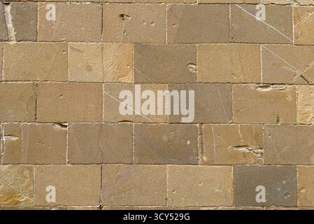 Detailed texture of an old sandstone wall with weathered rectangular stone blocks Stock Photo