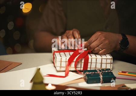 Black Family Arranging Wrapped Christmas Gifts under Decorated Tree ...