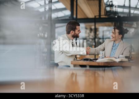 Professional meeting and handshake between two individuals in contemporary office space Stock Photo