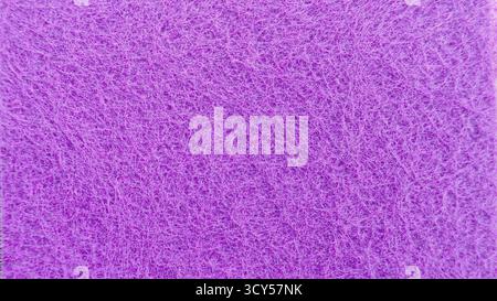 Vibrant Macro Purple Non-Woven Synthetic Scourer Pad Texture Background with Tangled Fibers, Ideal for Cleaning, Abstract, or Craft Concepts. Stock Photo
