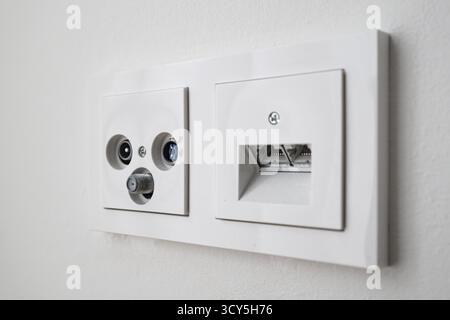 Cable Internet and phone socket installed on a wall Stock Photo
