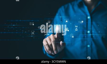 Futuristic biometric authentication technology concept. Man is touching a fingerprint scan with icons of secured access, data protection, network cybe Stock Photo