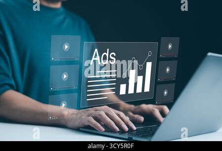 Digital Advertising Analytics and Video ADS Campaigns. Person using laptop analyzing digital ad performance metrics and campaign data. Digital market Stock Photo